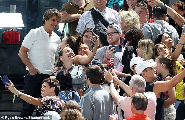 The 62-year-old actor had a big smile on his face as he posed for photos while walking to his seat at the Bercy Arena