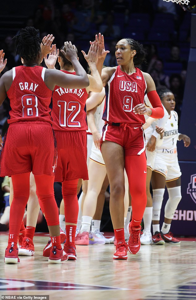 Team USA's A'ja Wilson, Diana Taurasi and Chelsea Gray high-five during a practice match against Germany