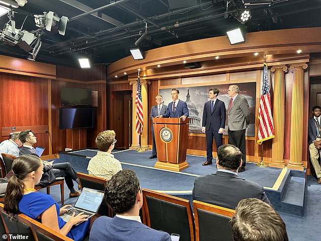 Sen. Josh Hawley speaks at a news conference announcing the congressional ban on stock trading on Wednesday, flanked by Democratic co-sponsors including Sens. Dick Durbin, D-Il., Ossoff and Peters