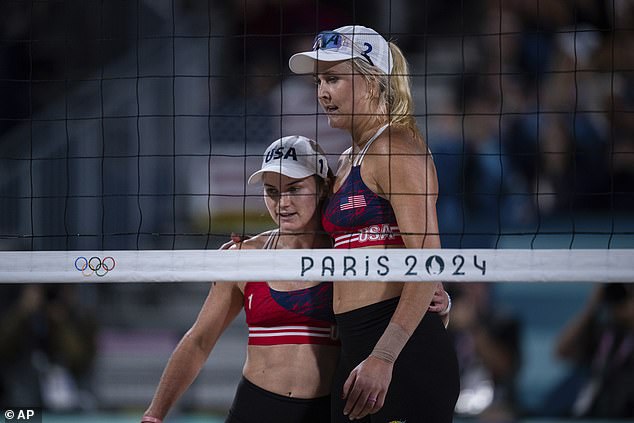 Kloth, right, and Nuss, left, celebrate victory in the women's beach volleyball match in Pool B