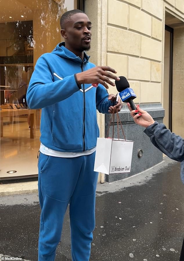 The man in the blue tracksuit is from Congo, but lives in Paris. He said: 'the boats were good'