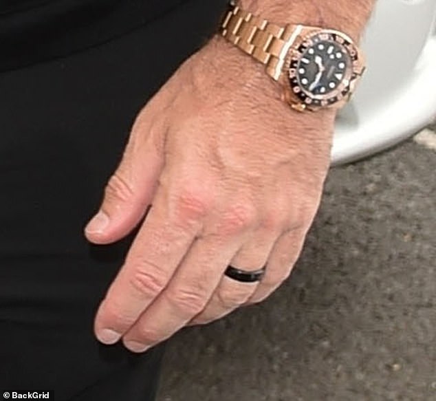 Tom also wore a thick band which he paired with a striking gold watch