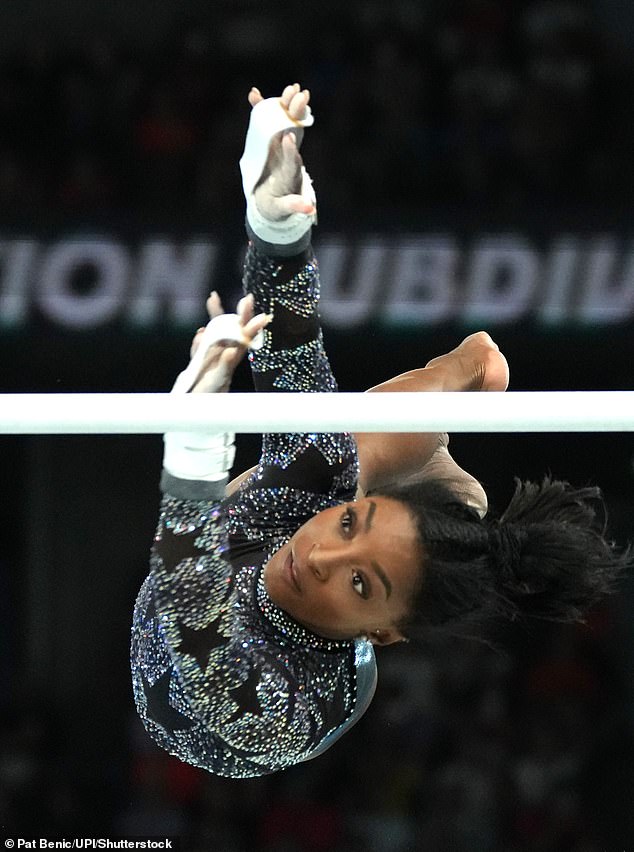 Biles achieves her uneven bars routine during Sunday's qualifying round