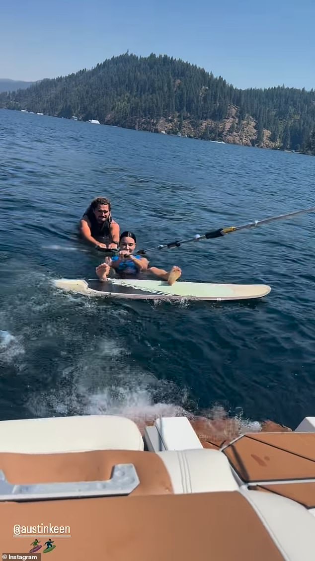 Austin was behind her in the photo from the boat and as she wakeboarded in the water