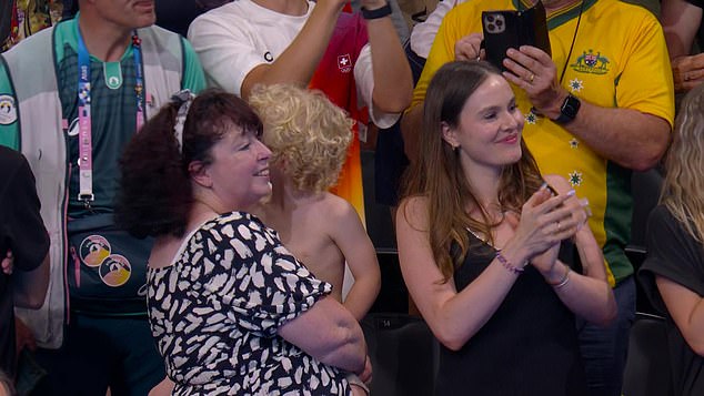 Peaty's mother Caroline, pictured with her grandson, was also among the crowd in Paris