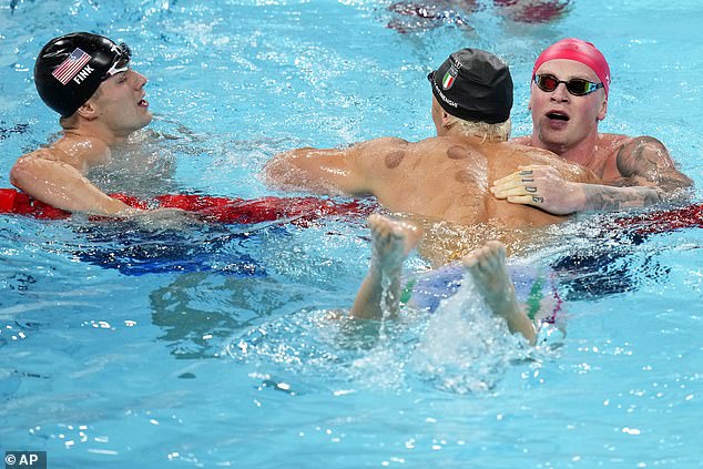 After the race, Peaty (right) is pictured congratulating champion Nicolo Martinenghi (centre)