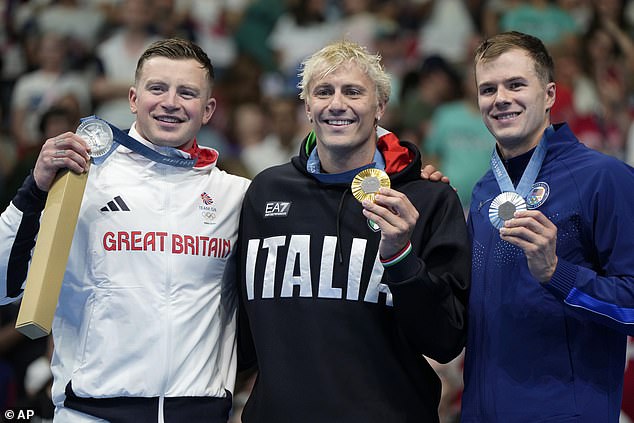 Italy's Nicolo Martinenghi (center) beat Peaty by just 0.02 seconds in Paris on Sunday night