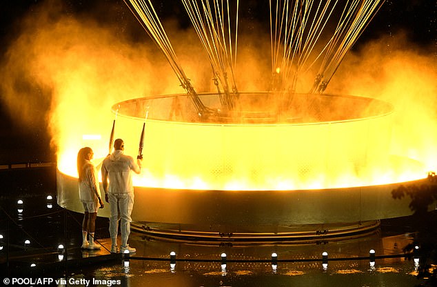 The cauldron, containing the burning Olympic flame, rises while attached to a balloon