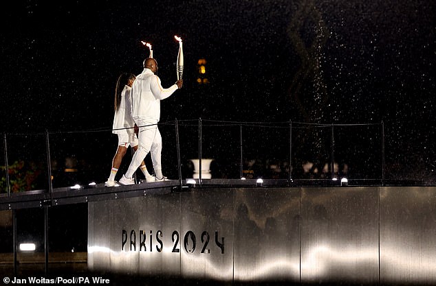 Marie-Jose Perec and Teddy Riner before lighting the Olympic flame during the opening ceremony