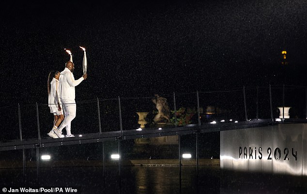 Marie-Jose Perec and Teddy Riner before lighting the Olympic flame at the opening ceremony of Paris 2024