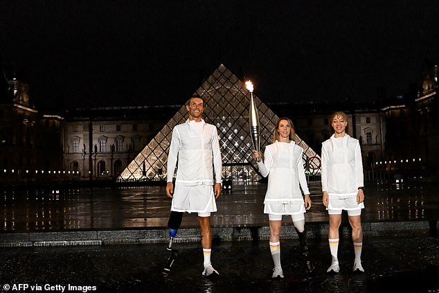 French Paralympic athlete Marie-Amelie Le Fur holds the Olympic flame