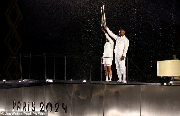 Marie-Jose Perec and Teddy Riner before lighting the Olympic flame at the opening ceremony of Paris 2024