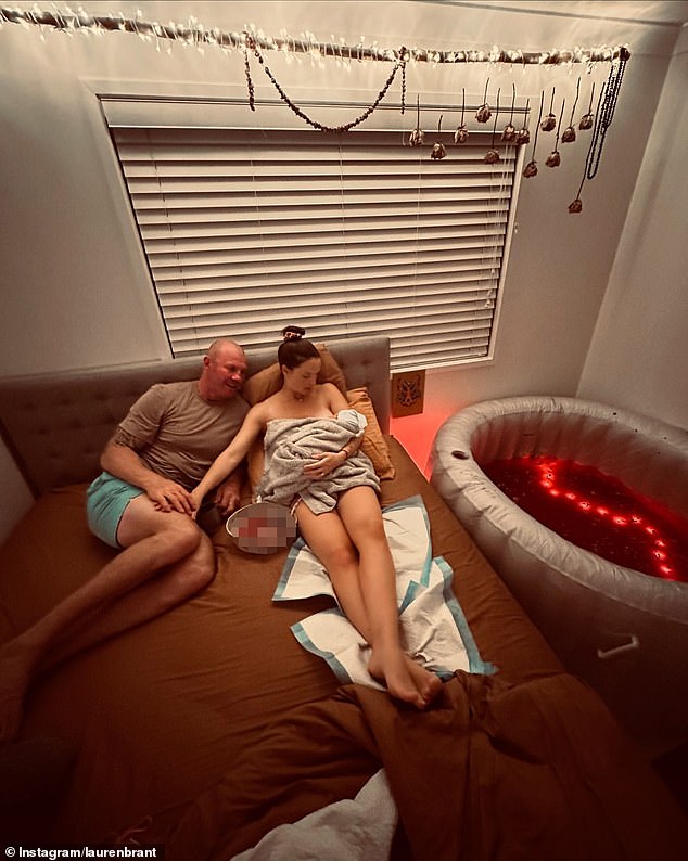 The couple shared a series of photos showing them cradling Clay in a birthing pool lit with red lights, and Lauren cuddling the newborn on a bed as a bowl of placenta sits next to them.