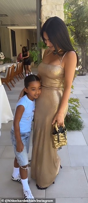 The playful moment was shared with Kim's six-year-old daughter Chicago, who clung to her glamorous mother's hip throughout the clip