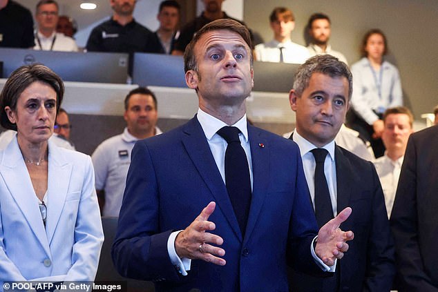 French President Emmanuel Macron (C) gives a speech next to Darmanin (R) during their meeting with French police officers at the Paris 2024 Olympic Games