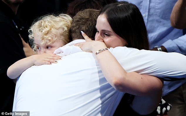 Holly gave him a kiss before George joined them in a hug and then she handed the little one to his dad