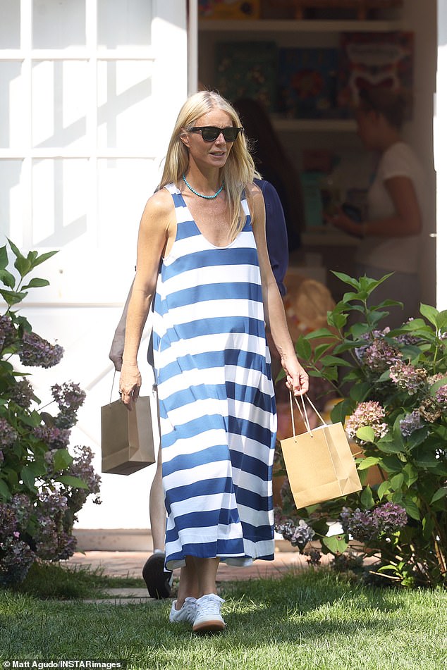 The actress, 51, showed off her effortless style in a flowing blue and white striped maxi dress, featuring a scoop neckline that showed off a glimpse of her cleavage