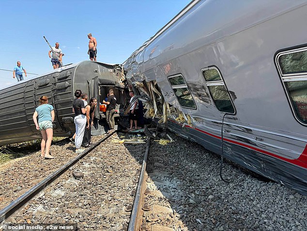 Dramatic images show wagons twisted and damaged next to the track after the collision