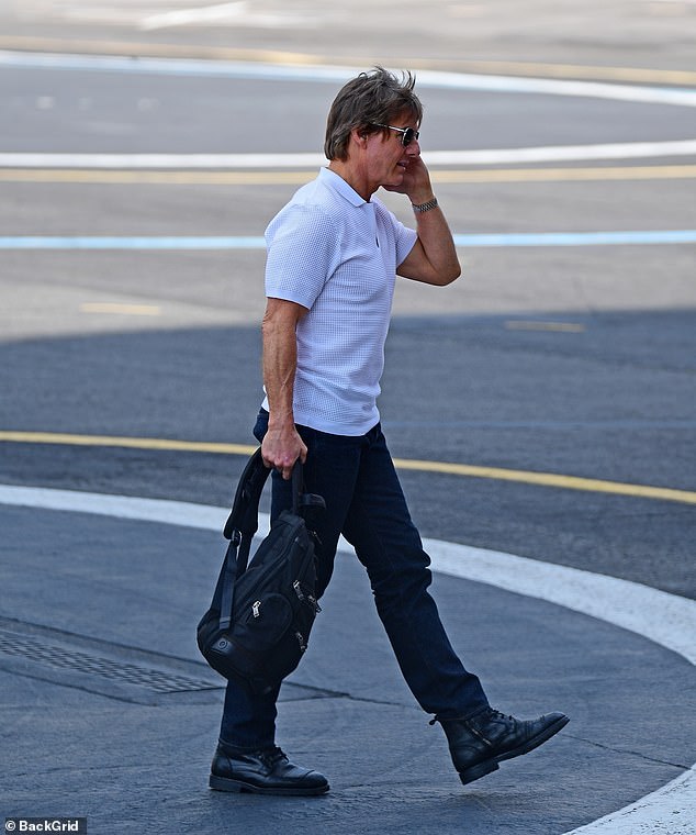 Cruise was spotted wearing a stylish white polo shirt with black aviator sunglasses and a silver watch