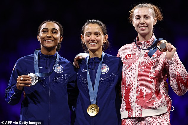 Scruggs (left) won silver in Paris, with his American teammate Lee Kiefer (center) taking gold