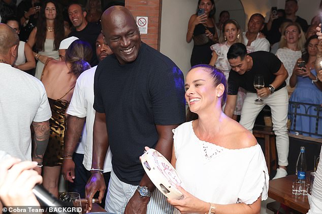 The couple got up from their table to dance as partygoers watched them.