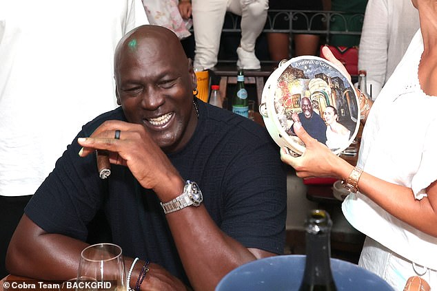 The couple appeared to have received a custom-made tambourine with their faces on it from the club