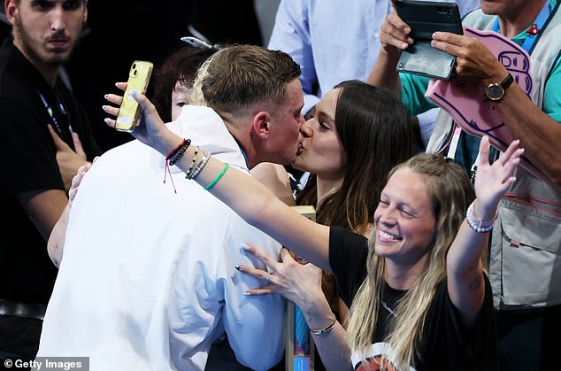 Peaty pictured kissing her girlfriend Holly Ramsey after the 100m breaststroke final on Sunday