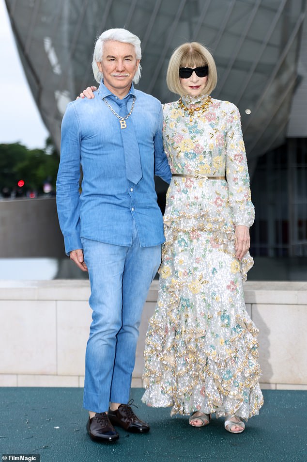 Anna wore a long-sleeved brocade dress with a thin gold belt and a pair of silver open shoes