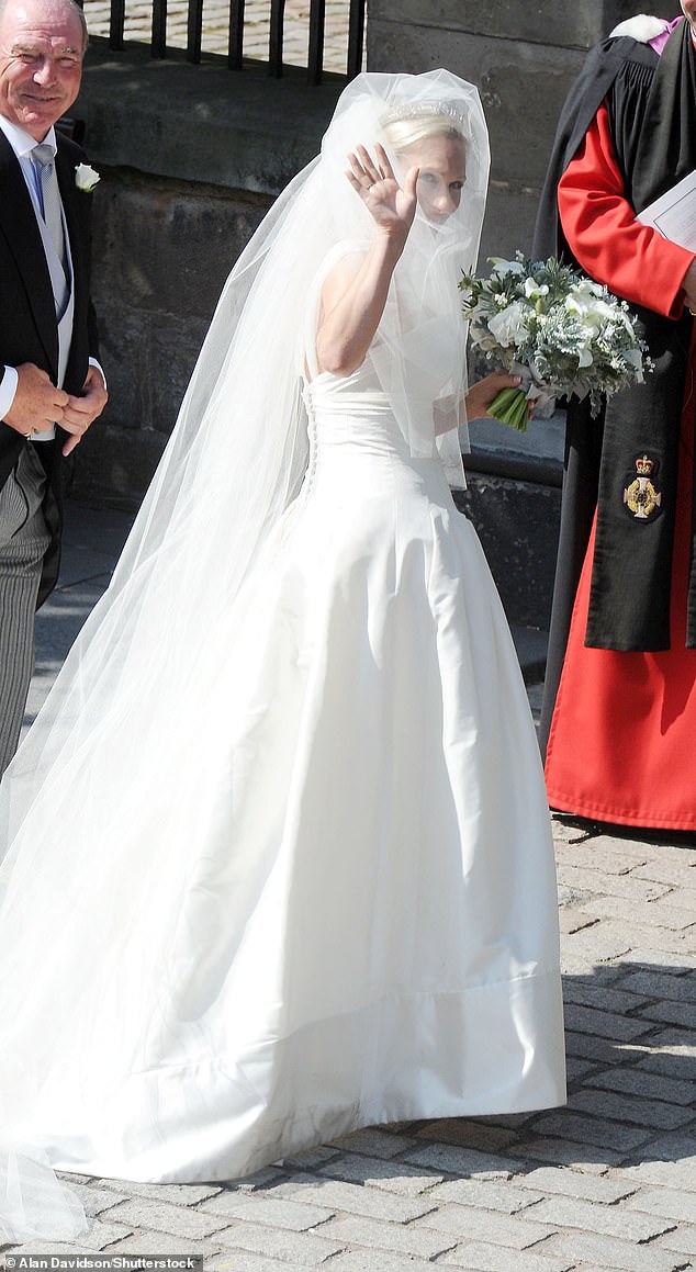 Zara pictured in her long wedding dress of beautiful ivory silk, with her father Captain Mark Phillips