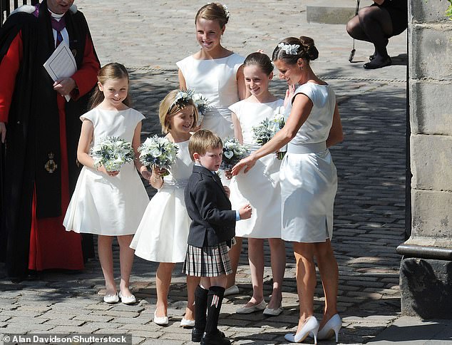 The bridal party is pictured gathering outside Canongate Kirk