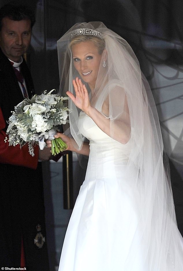 Zara pictured with a white flower arrangement at her wedding