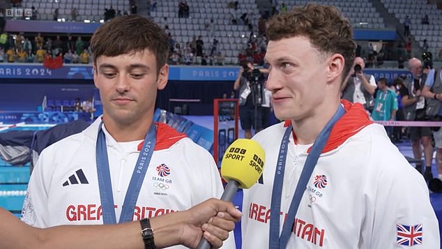 Williams (right) burst into tears as he discussed the death of his former coach Dave Jenkins after they won silver