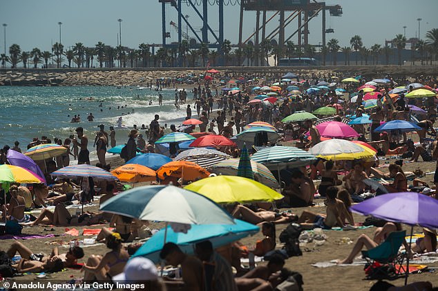 A general view of people spending time at La Malagueta beach during a hot summer day in Malaga