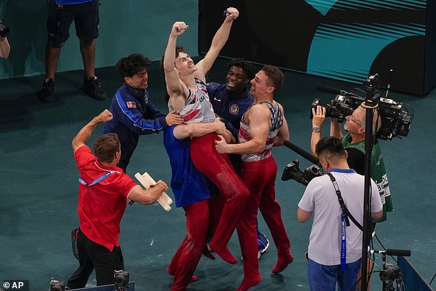 Nedoroscik is attacked by his teammates after his horse exercise at the Paris Games