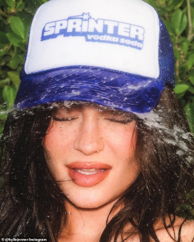 Kylie also wore a blue and white trucker hat from her brand as she posed with a snake