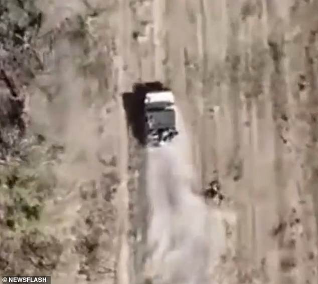 A clip shows a body flying from the Russian vehicle as it races through a field before an explosive is dropped