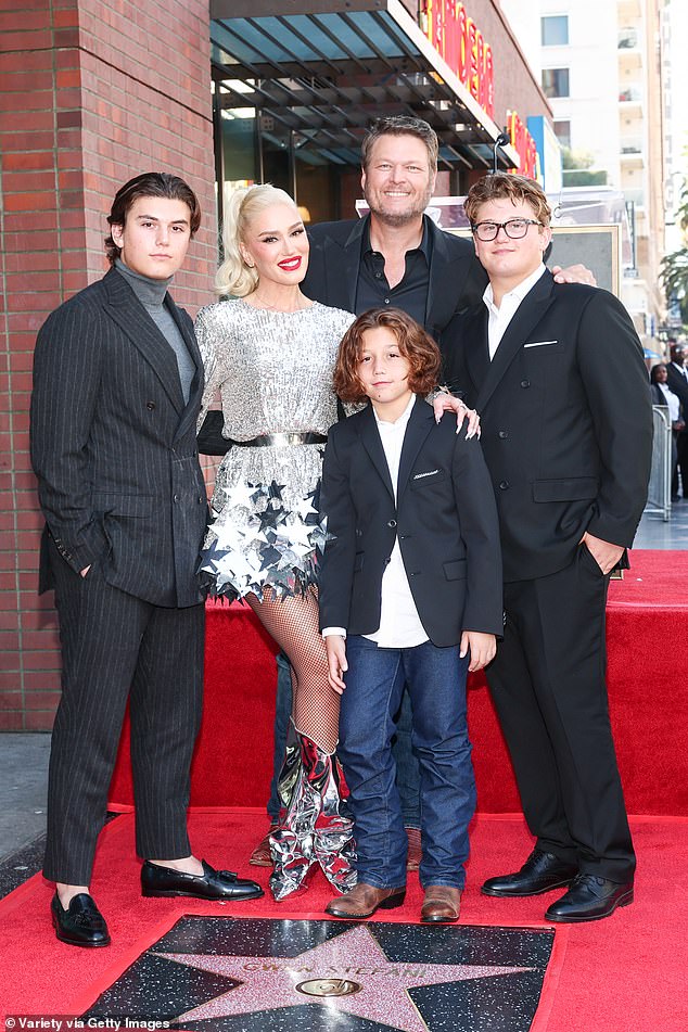 Shelton pictured (L-R) Kingston Rossdale, wife Gwen Stefani, Apollo Rossdale and Zuma in October 2023