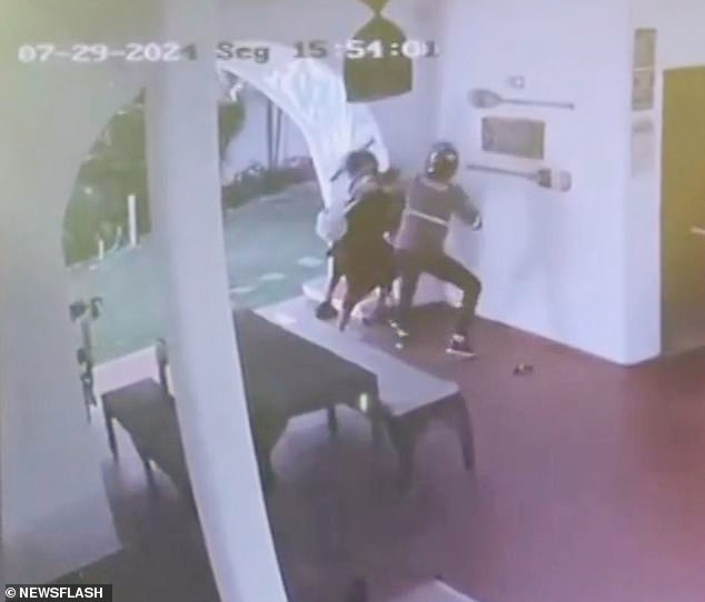 Terrifying surveillance footage shows the thief demanding their money before grabbing the Brazilian national and attempting to drag her away