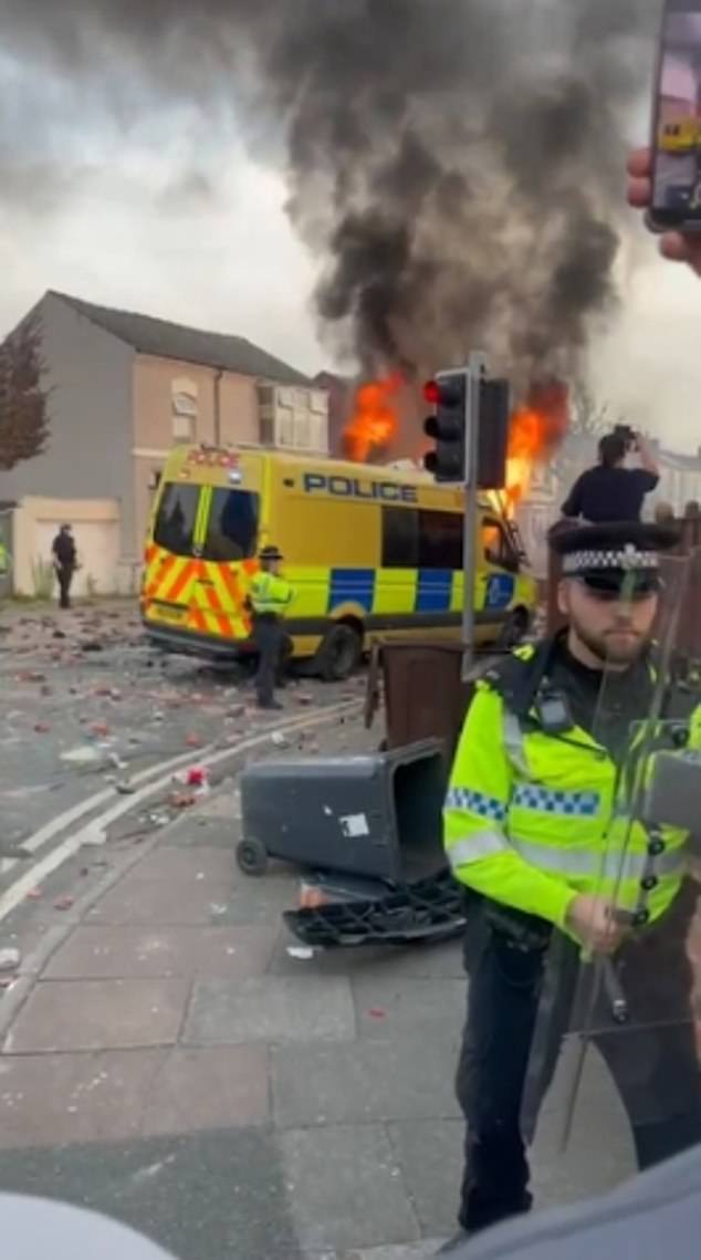 Garbage bins and rocks were thrown at police, while a police van was set alight - as police warned people not to speculate about the identity of the suspect