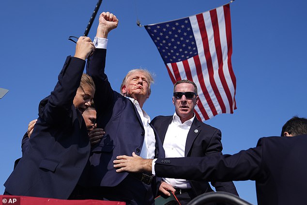 Former President Donald Trump raises his fist after being shot in the ear by Crooks on July 13