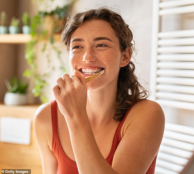 As for toothpaste, the dental hygienist said she chooses one with fluoride in it, which can help protect your teeth from cavities (stock image)