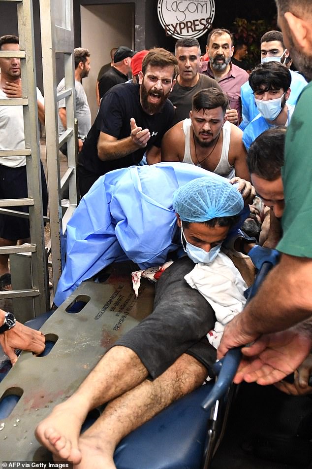 Medical workers in Beirut treat an injured man after an Israeli attack. Tensions rose as paramedics pulled victims from several damaged buildings, including a hospital