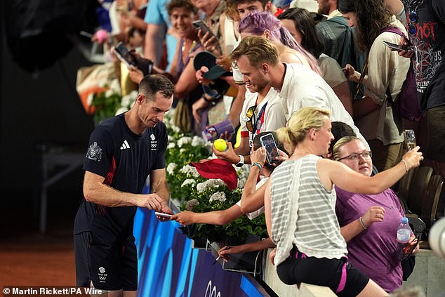 Murray signs autographs for fans after another dramatic victory in the men's doubles