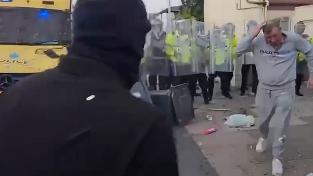 The protester tried to run away while holding the back of his head amid the violence