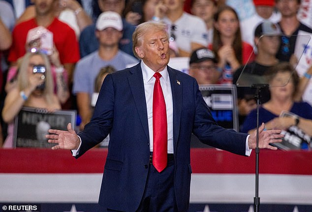 Republican presidential candidate Trump gestures during a rally with his vice presidential running mate, Sen. J.D. Vance, in St. Cloud, Minnesota, July 27, 2024