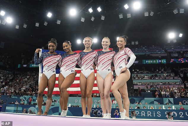 The team celebrated their gold medal by grabbing an American flag, jumping up and down, and taking time to pose for photos with fans