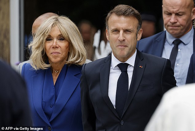 Macron, flanked by his wife Brigitte Macron, leaves after voting in the second round of the French parliamentary elections at a polling station in Le Touquet, northern France on July 7, 2024