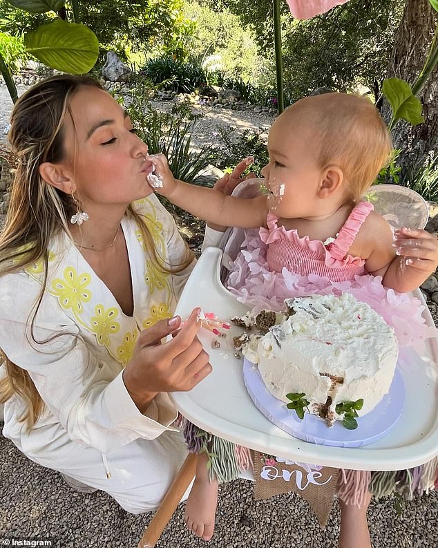 The little girl was given a white frosted cake with a large '1' on it as a memento of the occasion