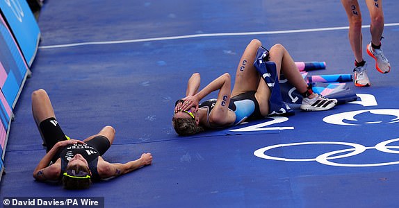 Britain's Beth Potter (left) after her bronze medal-winning third place in the women's individual triathlon at the Pont Alexandre III on day five of the Paris 2024 Olympic Games in France. Date of photo: Wednesday 31 July 2024. PA Photo. Photo credits should read: David Davies/PA Wire. RESTRICTIONS: Use subject to restrictions. Editorial use only, no commercial use without prior permission from the rights holder.