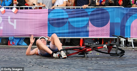 PARIS, FRANCE - JULY 31: Lotte Miller of Team Norway is seen after a fall during the women's individual triathlon on day five of the Paris 2024 Olympic Games at Pont Alexandre III on July 31, 2024 in Paris, France. (Photo by Lars Baron/Getty Images)